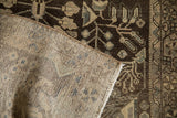 Tightly woven back and distressed chocolate brown floral pile on a Dargezine rug.