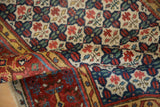 Intricate quatrefoil floral field and saffron henna border detail on an antique Bijar runner.