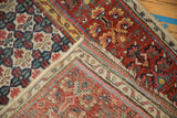 Antique Bijar rug detail showing striped hand-knotted back, machine-bound side, and traditional henna border.