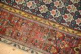 Cherry red henna plant main border, saffron yellow guard, and ivory vine minor border of antique Bijar rug.