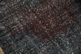Distressed Sparta runner close-up, highlighting worn texture and subtle violet-teal tones.