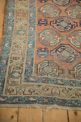 Antique Northwest Persian runner's geometric guls and bordered patterns in soft peach, blue, and olive.