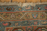 Antique Northwest Persian runner fringe and geometric border details in muted blues, madder red, and olive tan.
