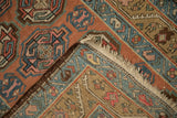 Detail of antique Persian runner side cord selvage, fringe, and geometric floral pattern.