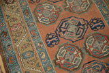 Geometric guls on the time-softened orange field of an antique Northwest Persian runner.