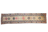 Vintage Distressed Kurd runner with geometric pink and navy medallions on an abrashed gold field.