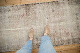 Distressed antique Mahal runner showcasing heavy wear, visible foundation, faded red, and ivory.