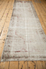 Distressed pile of the antique Mahal runner, showing foundation and faded red motifs.