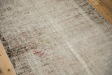 Textural close-up of distressed antique Mahal rug, showing foundation and faded motifs.