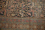 Antique Khorassan rug's madder red border, powder blue florals, and intricate field vinery.