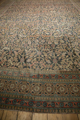 Antique Persian Khorassan carpet showing wear across ornate border and field's stylized arabesques.