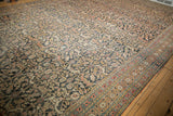 Antique Khorassan rug detail: navy field, madder red and gold dragon arabesques, visible wear to knot heads.