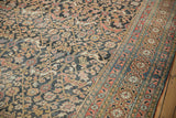 Antique Khorassan carpet displays worn dragon stylized arabesques, vinery, and madder root border.