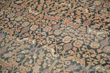 Detailed weave of the Antique Khorassan carpet's navy and madder red vinery, showing storied patina.