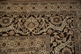 Ornate corner spandrel and border details of a distressed Tabriz in shades of chocolate brown and sand.