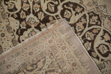 The hand-knotted foundation and restored side selvage of a distressed Persian Tabriz carpet corner.