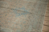 Distressed Karaja rug detail with geometric apricot, sky blue motifs, and visible wear.