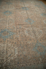 Vintage distressed Karaja rug showing geometric quatrefoil patterns in faded apricot and sky blue.