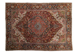 Vintage Distressed Heriz carpet featuring a burgundy field, blue medallion, and ivory florals, 8x11.