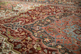 Distressed Persian Heriz carpet showing intricate burgundy, oxidized silver, and cream floral vines.
