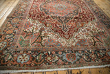 Distressed Heriz rug bottom border with gem-tone floral motifs and fringe.