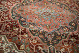 Distressed vintage Heriz rug showcasing intricate patterned field in rich burgundy and pale blue.