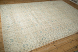 Distressed vintage Sparta rug corner, beige field, blue palmettes, and time-softened tones.