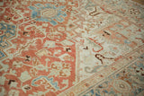 Even wear across the knot heads of a vintage Heriz carpet with terracotta and dusty blue motifs.