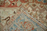 Hand-knotted construction and machine-bound edge visible on the folded corner of a vintage Heriz rug.