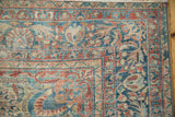 Distressed Lilihan carpet corner with sapphire blue, pale red floral palmettes, and visible wear.