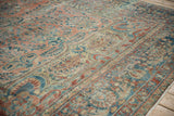 Distressed Lilihan carpet detail showing floral sprays, pomegranates, sapphire blue, and worn patina.