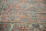 Distressed Lilihan carpet showing faded ruby red and sapphire floral patterns with exposed foundation.