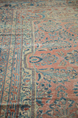 Faded pile and distressed ruby red, sapphire blue floral sprays on a vintage Lilihan rug.