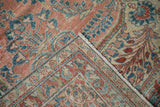 Distressed vintage Lilihan rug corner, revealing fringe and a pomegranate-palmette border.