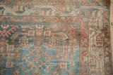 Distressed Hamadan rug detail with geometric Herati design in blue, rust, and ivory.