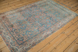 Textured pile and faded colors of the distressed Hamadan rug's geometric Herati field and vine border.