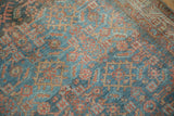 Distressed vintage Hamadan rug pile: geometric Herati design, blue, rust, and visible knot wear.