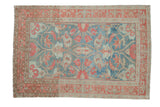 Distressed Persian Malayer rug with floral botehs, a faded raspberry border, and a soft denim blue field.