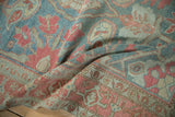 A soft drape in the vintage Malayer rug reveals its even wear and faded raspberry botehs.