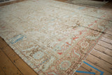 Distressed texture of a vintage Karaja carpet with ivory, powder blue, and red geometric field.