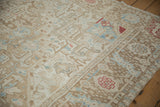 Distressed Karaja carpet pile, showing ivory, brown, powder blue, and red geometric patterns.