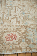 Distressed Karaja rug close-up: geometric pattern, red blossom, ivory, brown, blue hues.