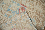 Vintage Karaja rug showing distressed ivory, powder blue geometric pattern, and machine bound side.