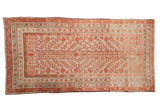 Antique Uzbeki Khotan rug with a coral red pomegranate and vine pattern on a time-softened seafoam green field.