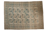 Vintage distressed Ersari carpet with a geometric gul pattern in muted indigo, copper, and greige tones.