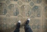 The even wear and low-pile texture of a distressed Ersari carpet with large-scale geometric guls.