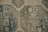 Color abrash across geometric gul motifs of a distressed, hand-knotted Ersari carpet.