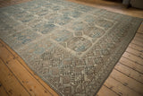 Corner detail of a distressed Ersari carpet with a geometric finned border in sandalwood and indigo tones.