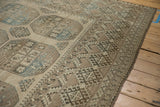 Detail of the distressed Ersari carpet's geometric gul and finned diamond-shaped border.