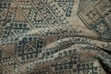 Textured, hand-knotted pile on a distressed Ersari carpet in shades of indigo and greige.